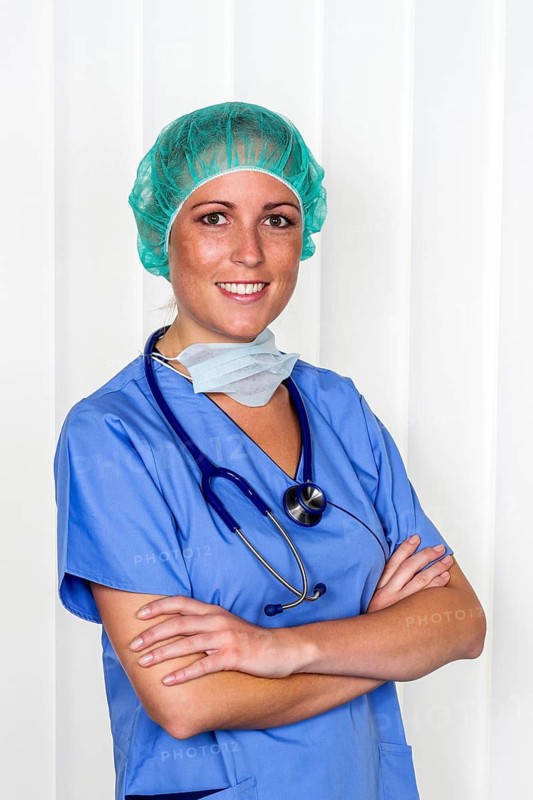 A nurse or doctor, female doctor, in surgical clothing in front of an operation. Symbolic photo for stress and overtime in hospital, studio shot, a nurse in surgical clothing in front of an operation. Symbolic photo of stress and overtime in hospital, studio shot, Vienna, Austria