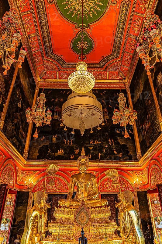 Beautifully furnished temple room with golden Buddha statue, sparkling chandeliers and pond-decorated wall and ceiling elements, Wat Paramai Yikawat Buddhist temple complex, Koh Kret river island, Bangkok, Thailand