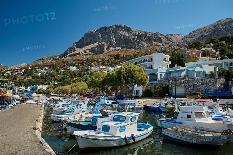 Melitsaches, harbor, small harbor full of boats, framed by a village in a mountainous landscape, Kalymnos, Sponge Diving Island, Dodecanese, Greek Islands, Greece