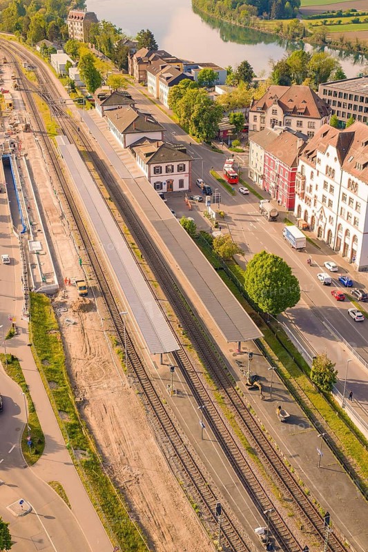 Railway station in the city with tracks, surrounded by trees and buildings in summer weather, electrification of the Hochrheinbahn, conversion of the station, Waldshut, Tiengen, Germany