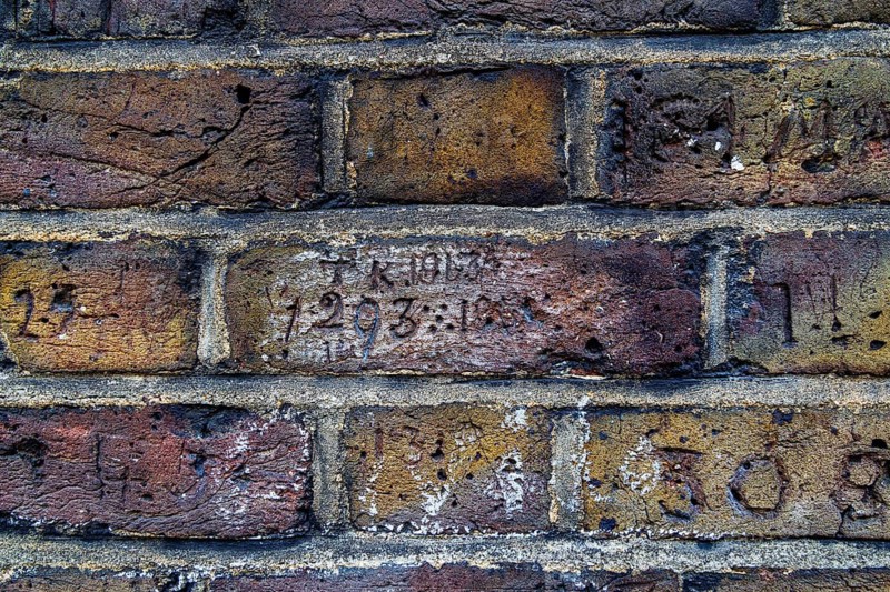 Secret London. The initials TK and the year 1913 are carved into a brick along Myddelton Passage in Clerkenwell, a marking research has linked to Thomas Kirkpatrick, a former Dumfries gamekeeper who joined the Metropolitan Police in 1910. London, England, United Kingdom