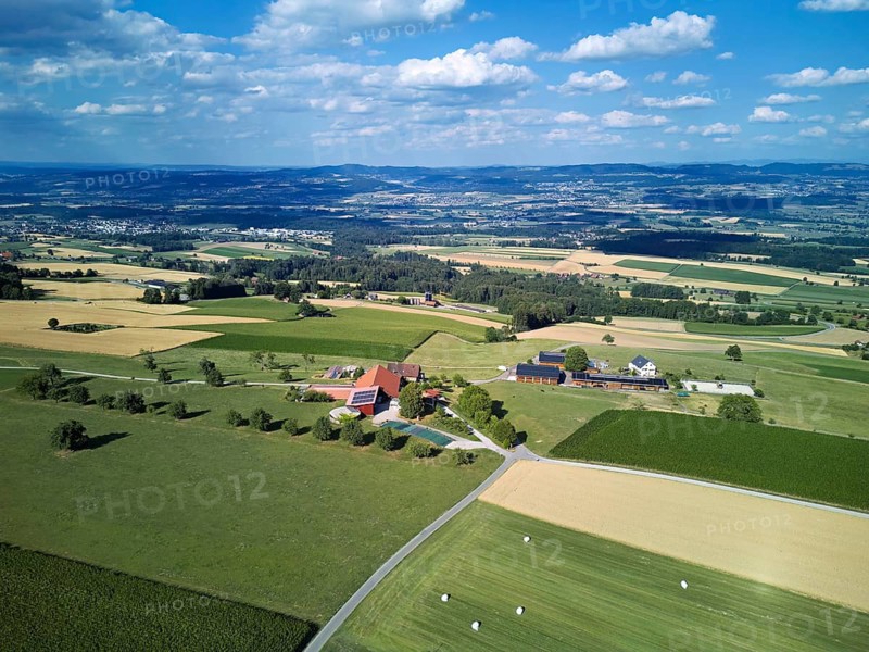 View of a farm with a photovoltaic system on the roof, the Reuss Valley in the back, Weiler Grod, Beinwil Freiamt, Canton of Aargau, Switzerland