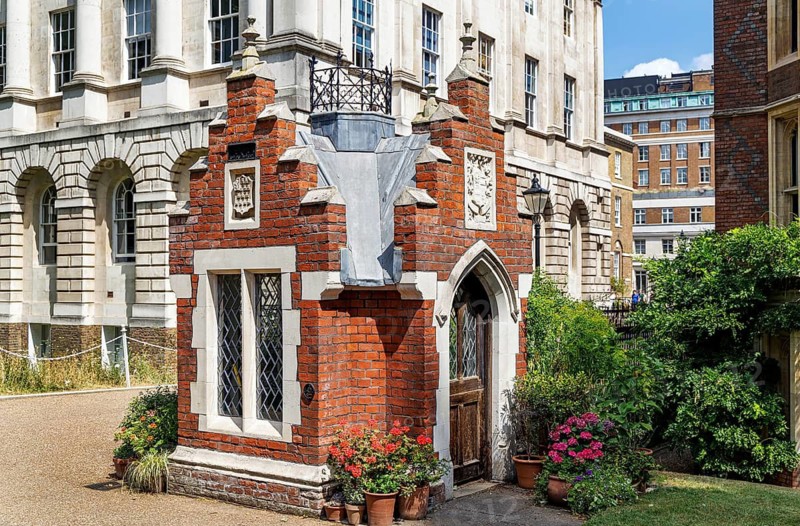 This front view of Ostler's Hut at Lincoln's Inn shows its arched doorway and small glass window, features of a tiny nineteenth century lodge built around 1860 for the ostler who once cared for horses. It is commonly described as London's smallest listed building. London, England, United Kingdom