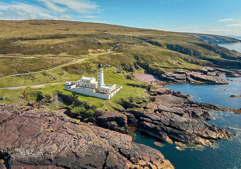 Aerial photo of the lighthouse on the rocky red cliffs of Rua Reidh point, Gairloch, Scotland, UK