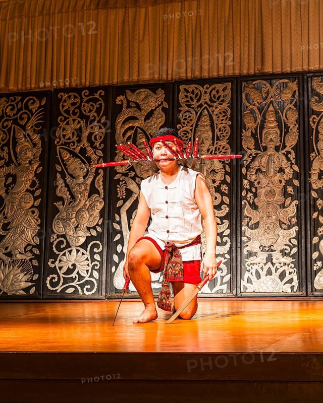 Young Thai man in traditional clothing in a historic show with knives and swords, Old Chiang Mai Cultural Center, Chiang Mai, Thailand