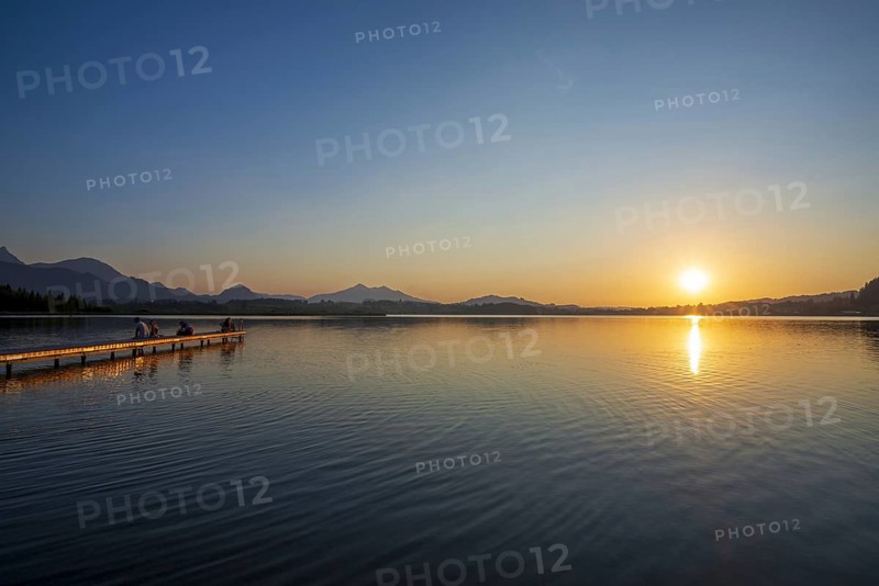 People enjoy sunset at Hopfensee near Füssen, Ostallgäu, Allgäu, Upper Swabia, Swabia, Bavaria, Germany