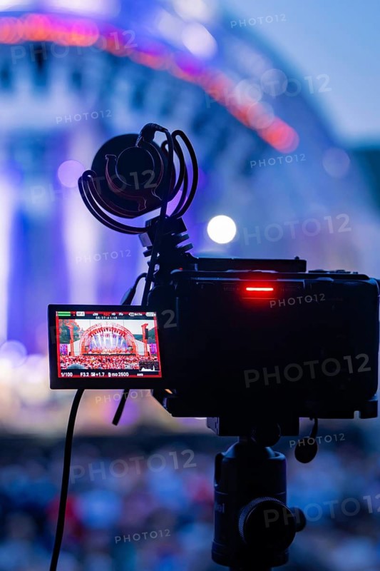 Camera with microphone films a colorful concert stage during a live stream, Calwer Klostersommer Festival, Hirsau Abbey, Calw, Germany