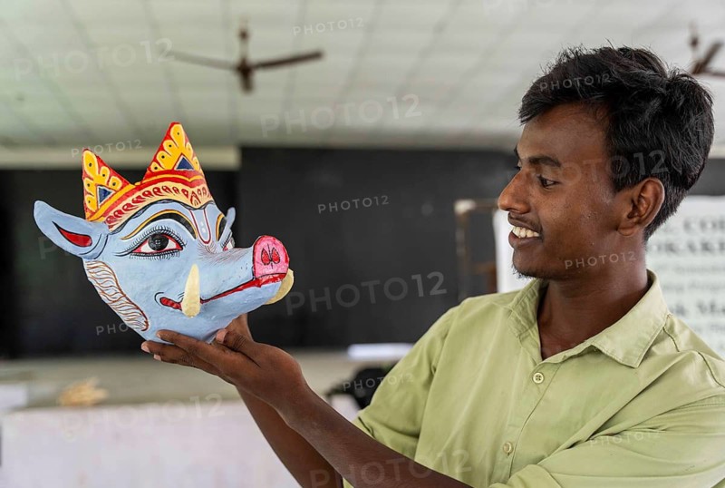 A student holds a traditional mask he created, in a traditional mask-making workshop during an internship programme at J.D.S.G. College on Wednesday 8 July 2026 at Bokakhat, in Golaghat district of Assam. Under the guidance of artisan Khagen Goswami from Sukumar Kala Peeth, Majuli, participants are trained in the traditional mask-making techniques of Majuli's centuries-old Sattriya cultural heritage