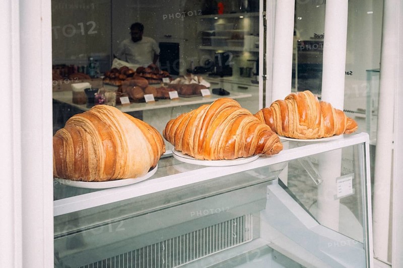 Oversized, freshly baked croissants in a bakery display, shop window, Paris, Paris department, Île-de-France, France