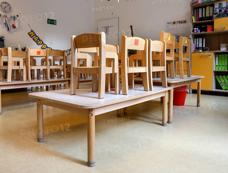 High-standing wooden chairs in the empty group room of a daycare center, Berlin, 11.08.2026, Germany