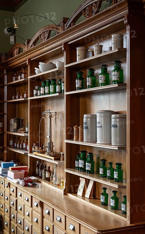 Mortar, glass apothecary bottles, apothecary scales, vessels on a shelf, the Svaneapoteket (Swan Pharmacy) from 1907 at the Jugendstilsenteret og KUBE museum, Ålesund or Alesund, Møre og Romsdal county, Norway