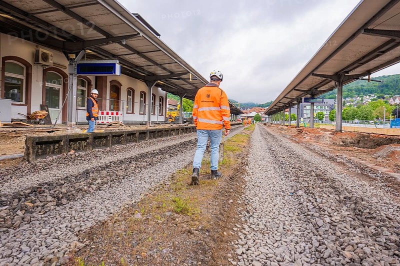 Construction workers at station blockage on rails, viewed from above, in cloudy skies, station conversion electrification Leonhard Weiß, Waldshut. germany