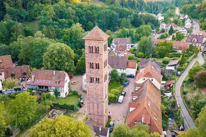 Picturesque village with historic tower, red roofs and green landscape, seen from the air, Calwer Klostersommer Festival, Hirsau Abbey, Calw, Germany