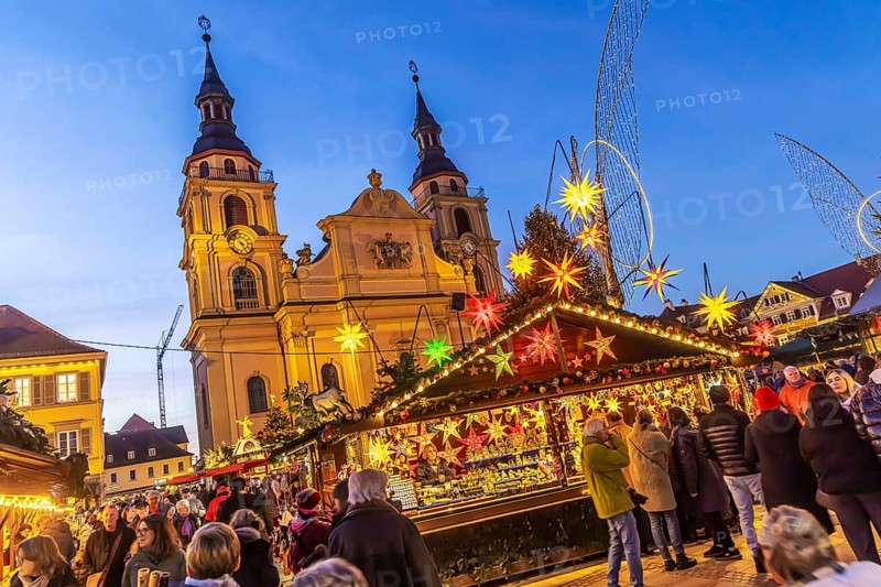 Baroque Christmas market with illuminated angels between the Protestant City Church and the Catholic Church of the Most Holy Trinity. Sights on the market square in the evening. Ludwigsburg, Baden-Württemberg, Germany
