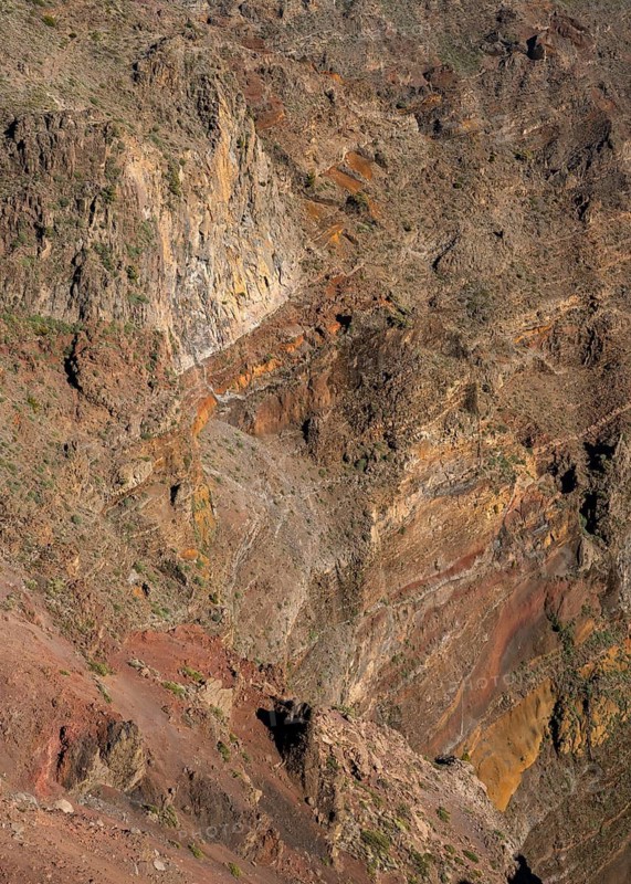 Different rock layers and layers of lava in yellow, orange, ochre and red in the Caldera de Taburiente. View from Roque de los Muchachos. La Palma, Canary Islands, Spain