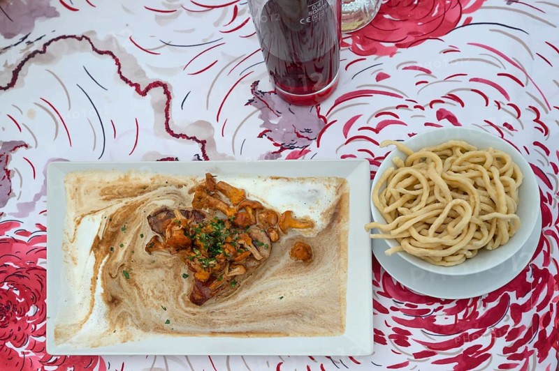 Creamed veal roast with fresh chanterelles and homemade spaetzle, served in a garden restaurant, Franconia, Bavaria, Germany