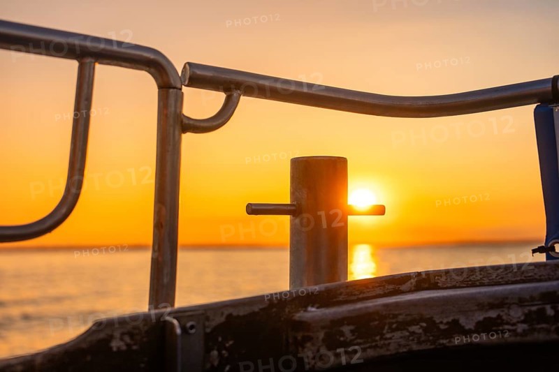 Sunset light shines through a boat railing, Howth, Ireland