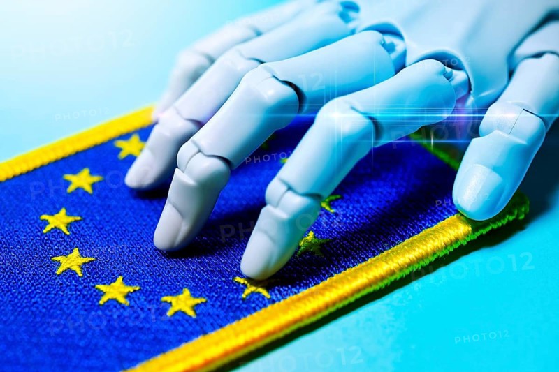 Robot hand on EU flag, AI laws and AI guidelines, photo montage +++ editorial use only
