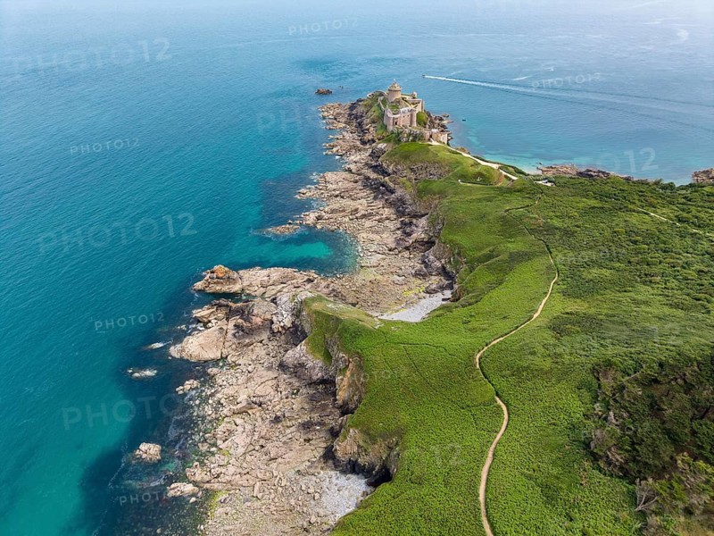 Aerial view of the historic rock castle Fort la slat, Château de la Roche Goyon on a rocky headland on the Emerald Coast, surrounded by the turquoise Atlantic Ocean, Plevenon, Côtes-d'Armor department, Brittany region, France