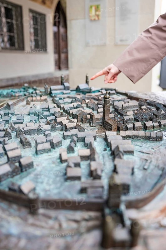 Hand points at a detailed city model with many buildings, Isny, Allgäu, Bavaria, Germany