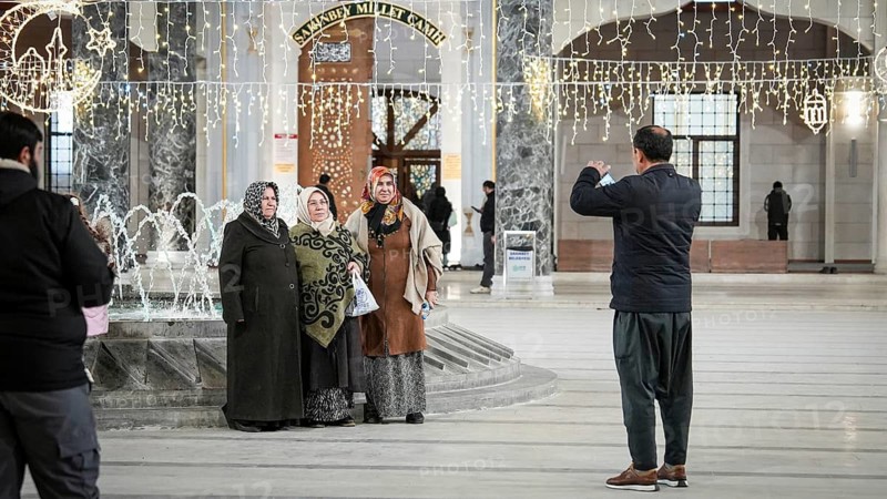 Muslim families and individuals gather at outdoor tables for a mass community Iftar meal under festive Ramadan lights in Gaziantep, Turkey on March 11, 2026, Gaziantep, Turkey