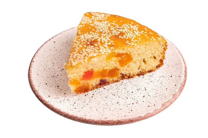 Pie with candied fruit isolated on white background, close up, side view