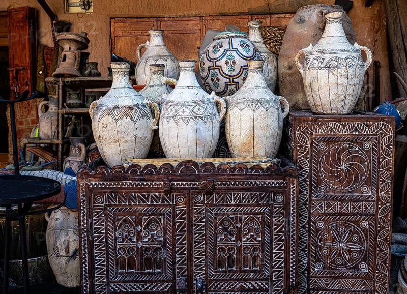 Ancient everyday objects, painted clay jugs, carved decorated wooden doors on display for sale, souk, bazaar, Marrakech, Maghreb, South Morocco, North Africa