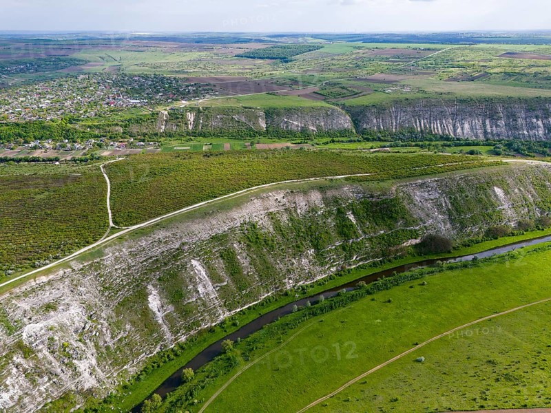 Rising hill ranges surrounding a river in a green agricultural region, aerial view, landscape on the Raut River, Raut, Old Orhei, Orheiul Vechi, archaeological site, protected landscape area, Orhei district, Republic of Moldova, Moldova