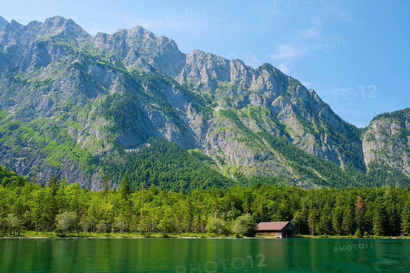 Lakefront view of Konigsee in Bavaria, Germany, with a small boathouse below the Berchtesgaden Alps and Watzmann massif