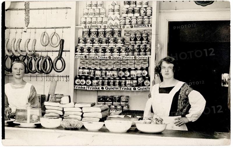 Colonial goods, shop, profession, twenties, saleswoman, shop display, interior view of a grocery store with two woman and shelves full of products, around 1925