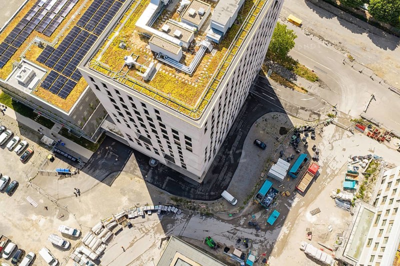 Aerial view of a modern building with green roof and solar panels in an urban environment, new hospital building, Böblingen airfield, Germany