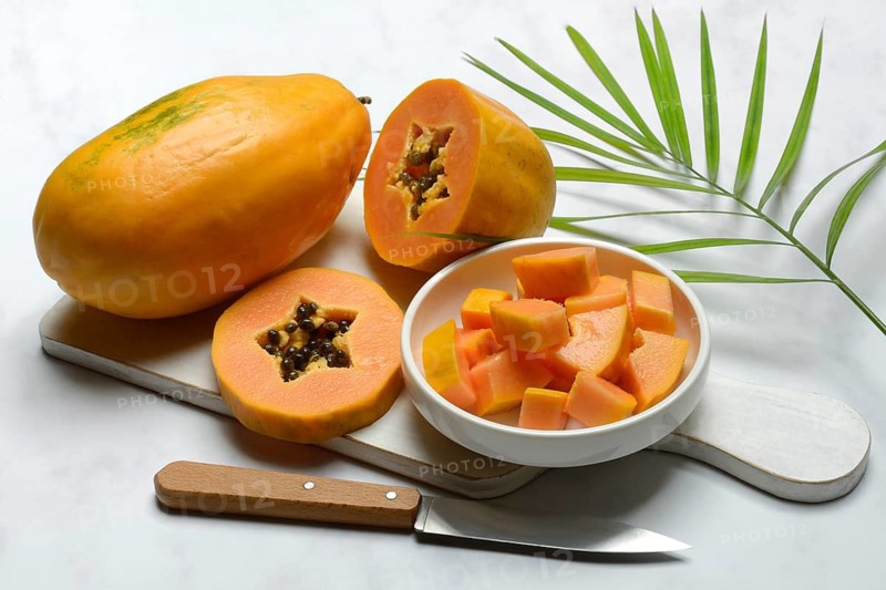 Pawpaw, split fruit in skin, halved and whole fruit, Carica papaya