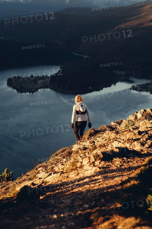 Trail running in autumn on the Jochberg on Lake Walchensee against the wonderful backdrop of the Alps, Bavaria, Germany