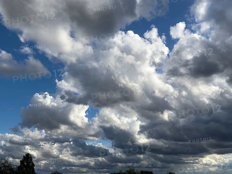 Large cloud field of dark cumulus cluster clouds at the bottom announce rain rain clouds rain front, international
