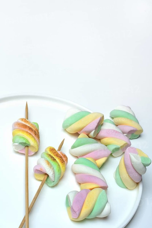 Marshmallows on skewers, pastel-coloured foam sugar