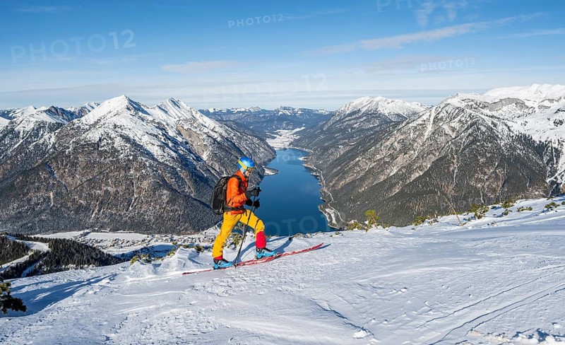 Picturesque view of Achensee and wintry mountain scenery, ski tourers at the summit of Bärenkopf, Achensee, Tyrol, Austria