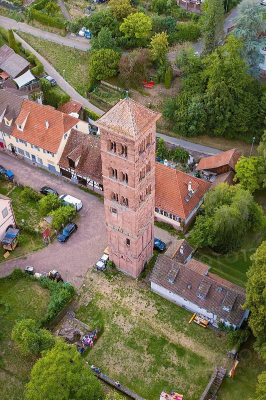 Historic tower in a rural area, surrounded by red roofs and green trees, from a bird's eye view, Calwer Klostersommer Festival, Hirsau Abbey, Calw, Germany