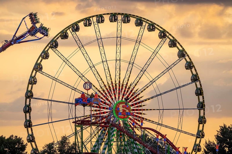 Rhine fair in the Rheinwiesen in Düsseldorf-Oberkassel, rides in the evening, with lots of lighting, Ferris wheel, infinity, world's largest mobile overhead swing, Wilde Maus rollercoaster, North Rhine-Westphalia, Germany