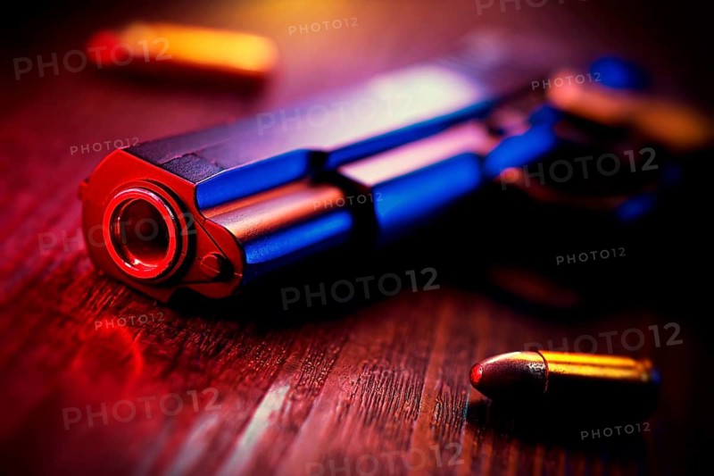 Gun with cartridges, force of arms, photo montage +++ editorial use only