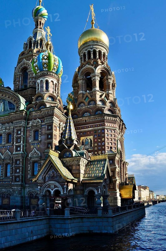 Impressive domes of a Russian church in sunlight with a river in the foreground, Church of the Resurrection, Saint Petersburg, St. Petersburg, Russia