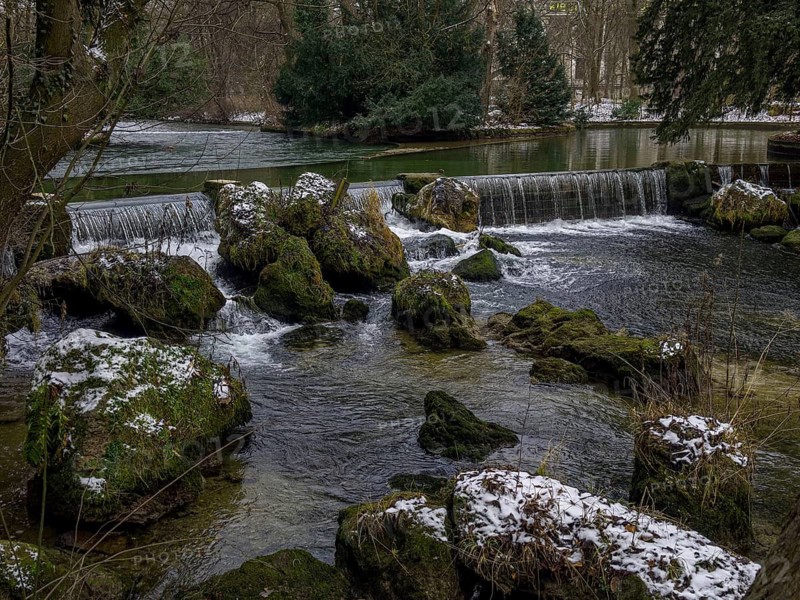 Small waterfall, winter in the English Garden, Munich, Bavaria, Germany