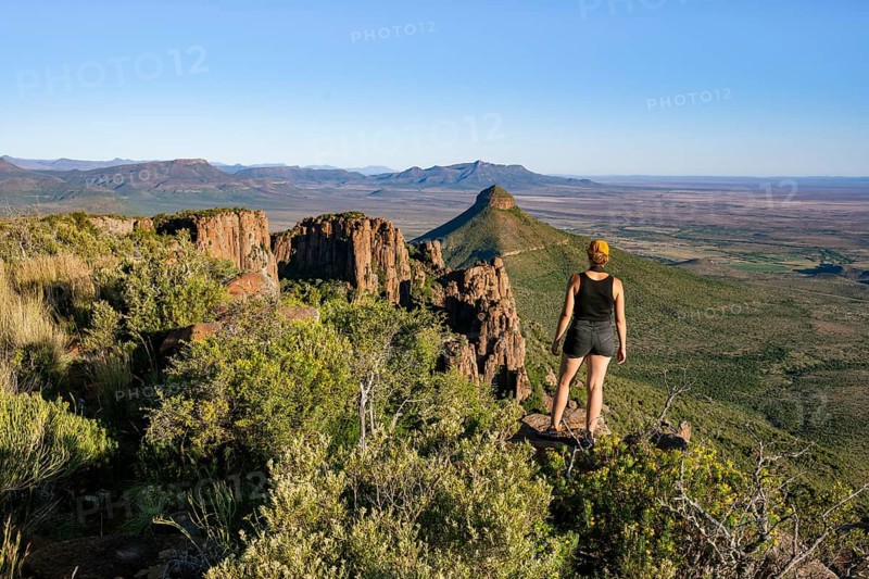 Young woman looking at the Valley of Desolation, eroded rock needles from Dolorit, Camdeboo National Park, Graaff-Reinet, Eastern Cape, South Africa
