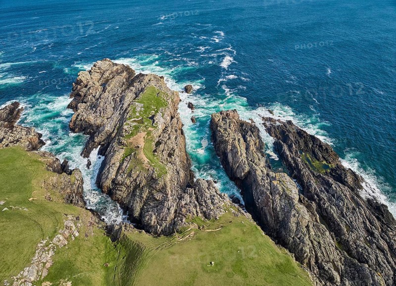 Aerial drone photo of rocky cliffs and heavy atlantic ocean surf, Strathy point, northern Scotland, UK