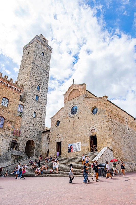 Towers of the old Town with historic buildings from Piazza del Duomo at San Gimignano on a sunny day, Tuscany, UNESCO World Heritage, Italy, Europe, Europe