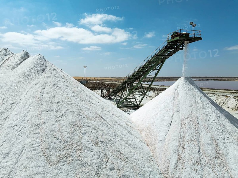Conveyor belt and salt heaps at the Walvis Bay Salt works. Aerial view. Drone shot. Walvis Bay, Namibia