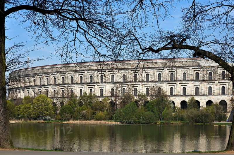 General view of the former, unfinished NSDAP Congress Hall, 1933–1945, with the Dutzenteich and lime trees (Tilia platyphyllos) in the foreground, Documentation Centre, Reich Party Rally Grounds, Bayernstraße 110, Nuremberg, Middle Franconia, Bavaria, Germany