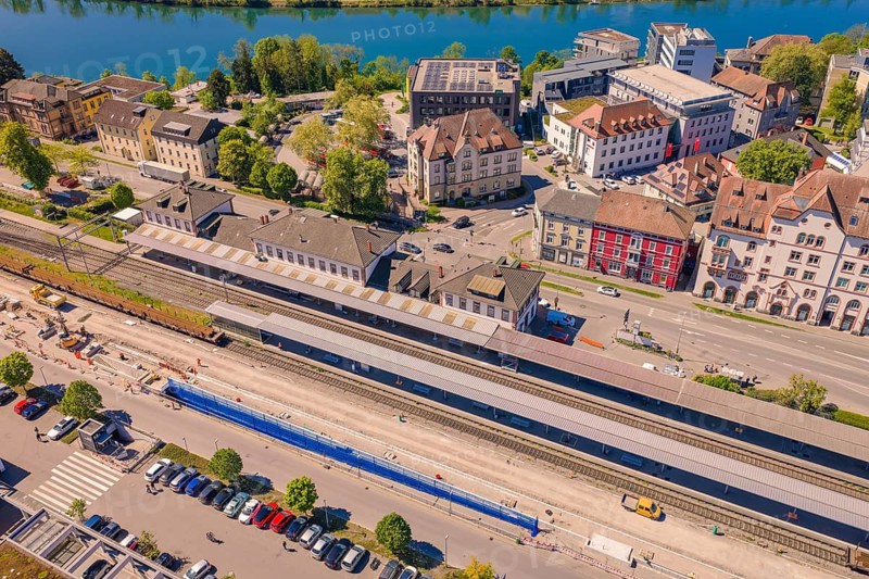 Urban area with railway tracks near a river, surrounded by historic buildings and green landscape in good weather, electrification of the Hochrheinbahn, conversion of the railway station, Waldshut, Tiengen, Germany