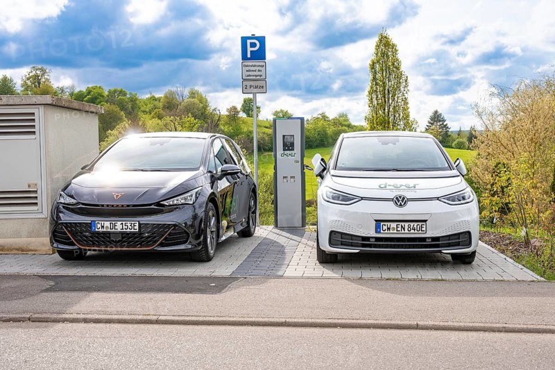 Two cars park at a charging station under the cloudy spring sky, Deer charging stations, Calw, Germany