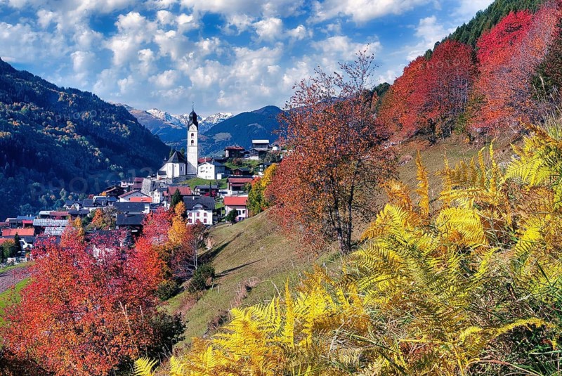 Village view of Sumvitg, autumn-coloured deciduous trees, Vorderrheintal Surselva, Canton of Graubünden, Switzerland