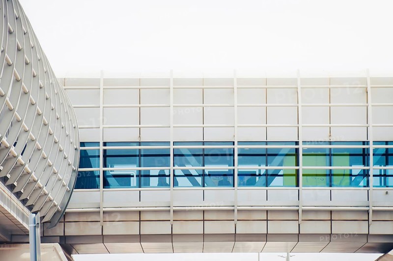 Cinematic exterior view Dubai Metro link bridge. This modern, air-conditioned pedestrian tunnel connects major transit hubs to luxury malls like Mall of the Emirates